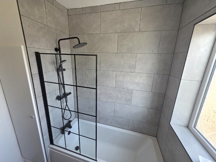 Grey bathroom with black framed shower screen